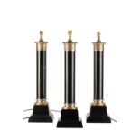 SET OF THREE BLACK PAINTED CAST IRON AND BRASS MOUNTED COLUMNAR TABLE LAMPS IN EMPIRE STYLE