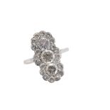 A THREE STONE DIAMOND CLUSTER RING