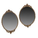 PAIR OF GILT COMPOSITION FRAMED OVAL MIRRORS