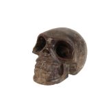 A CARVED MARBLE MODEL OF A HUMAN SKULL