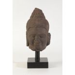 A SCULPTED LIMESTONE BUDDHISTIC HEAD