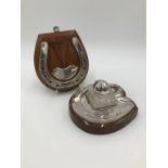 AN EDWARDIAN SILVER PLATED AND GLASS HORSESHOE INKWELL
