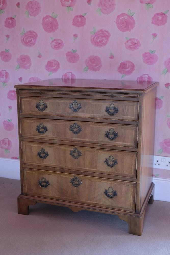 A GEORGE II STYLE WALNUT CHEST OF DRAWERS