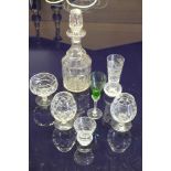 A COLLECTION OF CUT GLASS WINE GLASSES AND DECANTERS