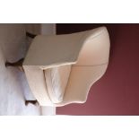 AN UPHOLSTERED TUB ARMCHAIR