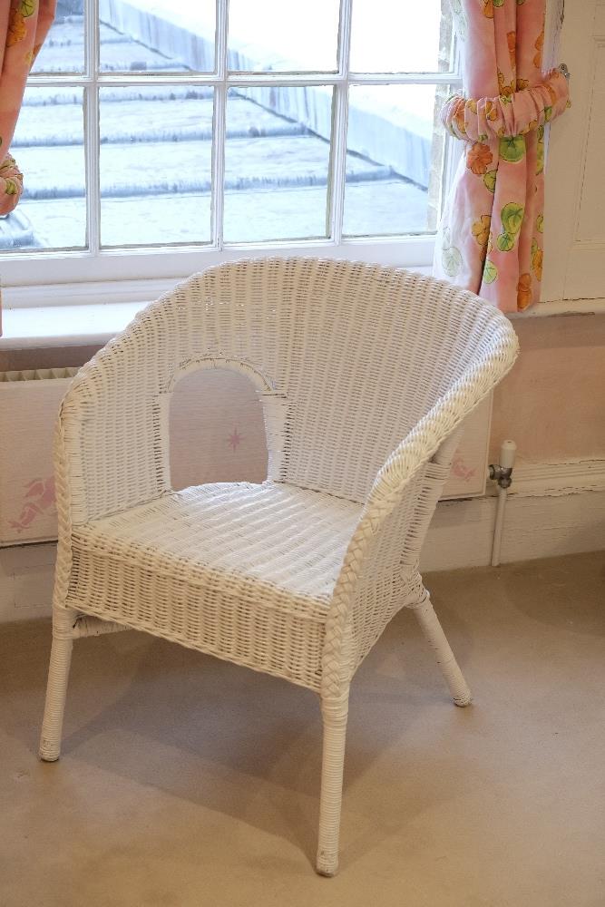 A WHITE PAINTED WICKER CHAIR