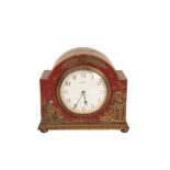 A RED JAPANNED MANTEL CLOCK