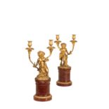 A PAIR OF GILT METAL AND MARBLE MOUNTED FIGURAL TWIN LIGHT CANDELABRA,