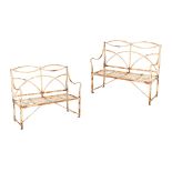 A PAIR OF REGENCY WROUGHT IRON GARDEN BENCHES,