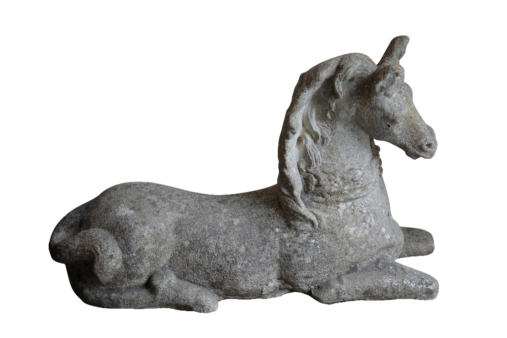 A STONE COMPOSITION GARDEN MODEL OF A RECUMBENT FOAL,