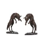 A PAIR OF PATINATED BRONZE MODELS OF FOXES, POSSIBLY BOOKENDS,
