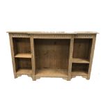 A CARVED AND STRIPPED OAK BREAKFRONT OPEN BOOKCASE,