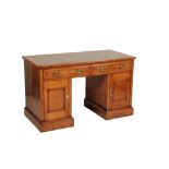 AN OAK AND LEATHER INSET PEDESTAL DESK IN GEORGE III STYLE,