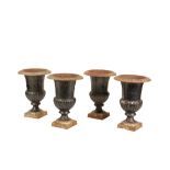 A SET OF FOUR BLACK PAINTED CAST IRON URNS