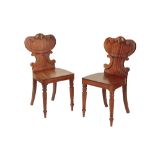 A PAIR OF REGENCY OR GEORGE IV MAHOGANY HALL CHAIRS,