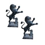 A PAIR OF SUBSTANTIAL IRON PIER FINIALS CAST AS RAMPANT LIONS,