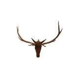 A CARVED WOOD AND ANTLER MOUNTED STAG'S HEAD WALL TROPHY,
