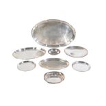 A GROUP OF EIGHT SILVER COLOURED DISHES,