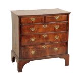 A GEORGE II WALNUT AND CROSSBANDED CHEST OF DRAWERS,
