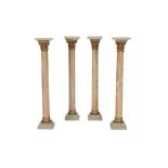 A SET OF FOUR EGYPTIAN STRIATED ALABASTER AND GILT BRONZE MOUNTED COLUMNAR PEDESTALS,