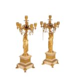 A PAIR OF FRENCH GILT BRONZE AND ONYX MOUNTED SIX LIGHT FIGURAL CANDELABRA,