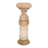 AN ITALIAN CARVED ALABASTER URN ON PLINTH,