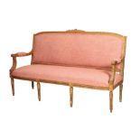 A CARVED AND GILTWOOD AND UPHOLSTERED CANAPÃ‰ IN LOUIS XVI STYLE,