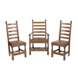 * NIGEL GRIFFITHS: A SET OF TWELVE HANDMADE LADDER BACK OAK DINING CHAIRS