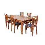 A CONTEMPORARY DORSET CHERRY WOOD DINING TABLE AND TEN CHAIRS