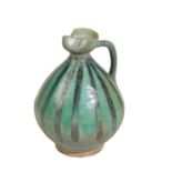 KASHAN GREEN-GLAZED POTTERY EWER, WESTERN PERSIA, 12TH CENTURY