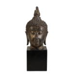 GILT-BRONZE HEAD OF A BUDDHA, THAILAND, 16TH CENTURY OR EARLIER