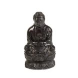 FINE CARVED AMBER FIGURE OF A SEATED BUDDHA, QING DYNASTY