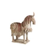 PAINTED POTTERY FIGURE OF A CAPARISONED HORSE, NORTHERN QI DYNASTYN