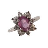 A PINK GEM STONE AND DIAMOND CLUSTER RING