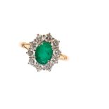 AN EMERALD DIAMOND CLUSTER RING