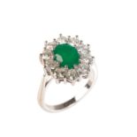 AN EMERALD AND DIAMOND CLUSTER RING.