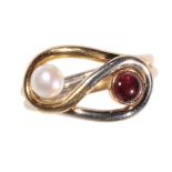 A PEARL AND CABOCHON GARNET RING