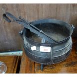 A CARRON IRON COMPANY CAST IRON COOKING POT with a wrought iron adjustable pot hanger