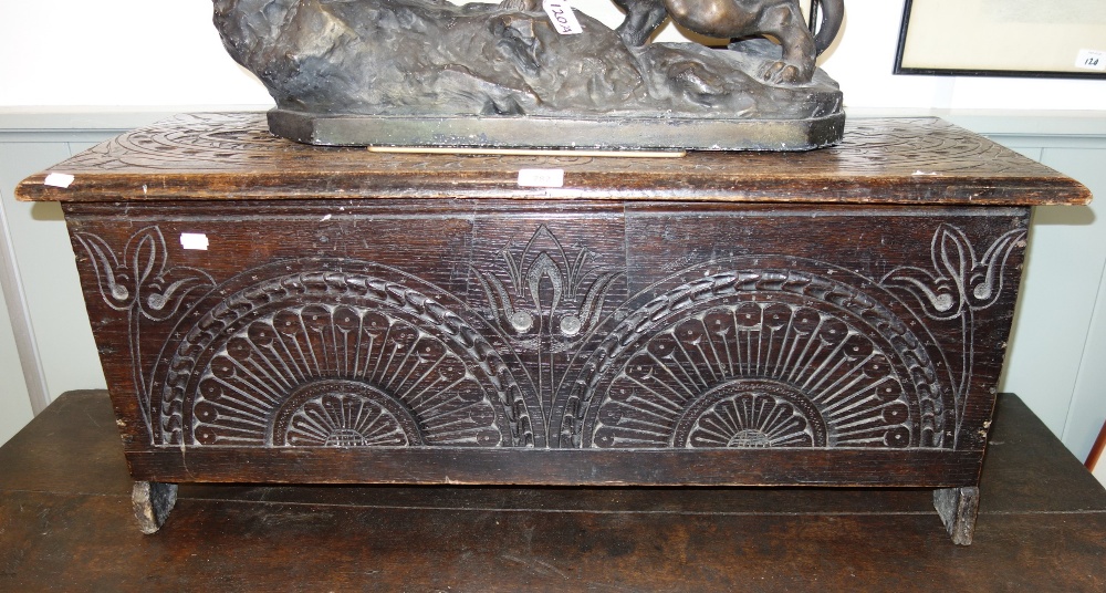 AN OAK COFFER WITH INCISED DECORATION of small proportions, 93cm wide