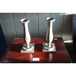 A PAIR OF EARLY 18TH CENTURY PEWTER CANDLESTICKS with touch marks and engraved initials, 20.5cm