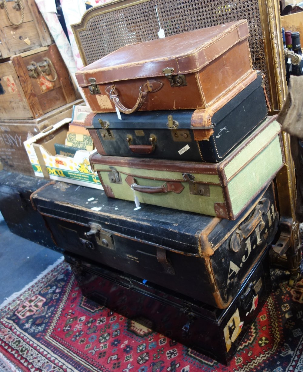 A JAPANNED TIN TRUNK, a canvas travelling trunk and three suitcases