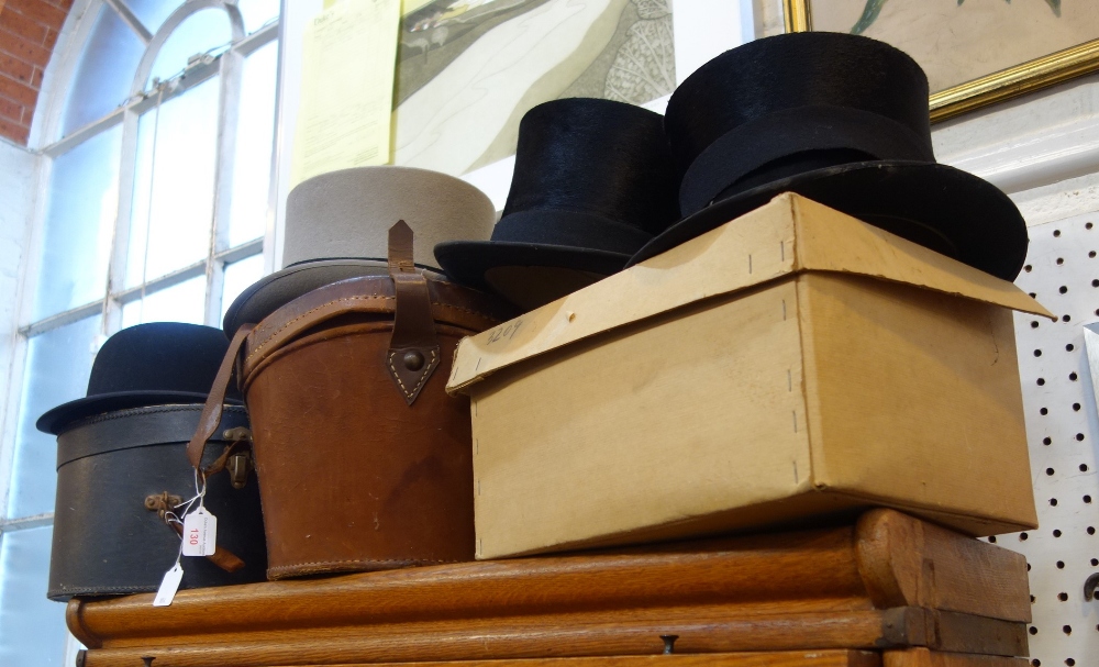 A VELVET LINED LEATHER TOP HAT BOX, two black top hats, a grey topper, a bowler hat and other hat