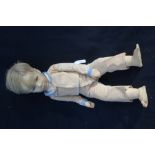 A 1920S BOY DOLL, with a composite painted head, with rear leather support and a fabric jointed