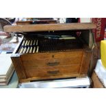 A 1930S OAK CANTEEN OF CUTLERY (some cutlery missing)