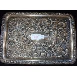 A SILVER TRAY, London, 1912, embossed with stylised flowers, 29.5cm long (c.10.1oz)