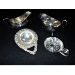 A COLLECTION OF MIXED SILVER, comprising a two silver cream jugs, wine taster and strainer (c.8oz)