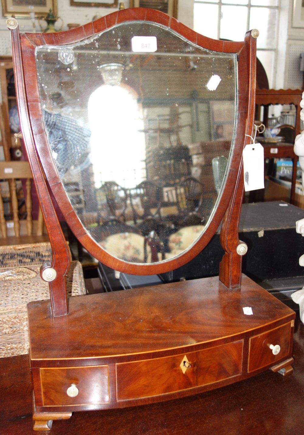 A GEORGE III MAHOGANY BOX BASE TOILET MIRROR with shield shaped plate and boxwood stringing