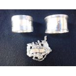 MIXED SILVER, comprising two silver napkin rings and a silver decanter label 'Whisky' (c.3.8oz) (3)