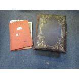 A VICTORIAN PHOTOGRAPH ALBUM containing family portraits and a collection of 19th century prints and