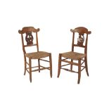 A COMPOSED PAIR OF INTERESTING NAPOLEONIC CARVED BEECH SIDE CHAIRS, early 19th century, the top